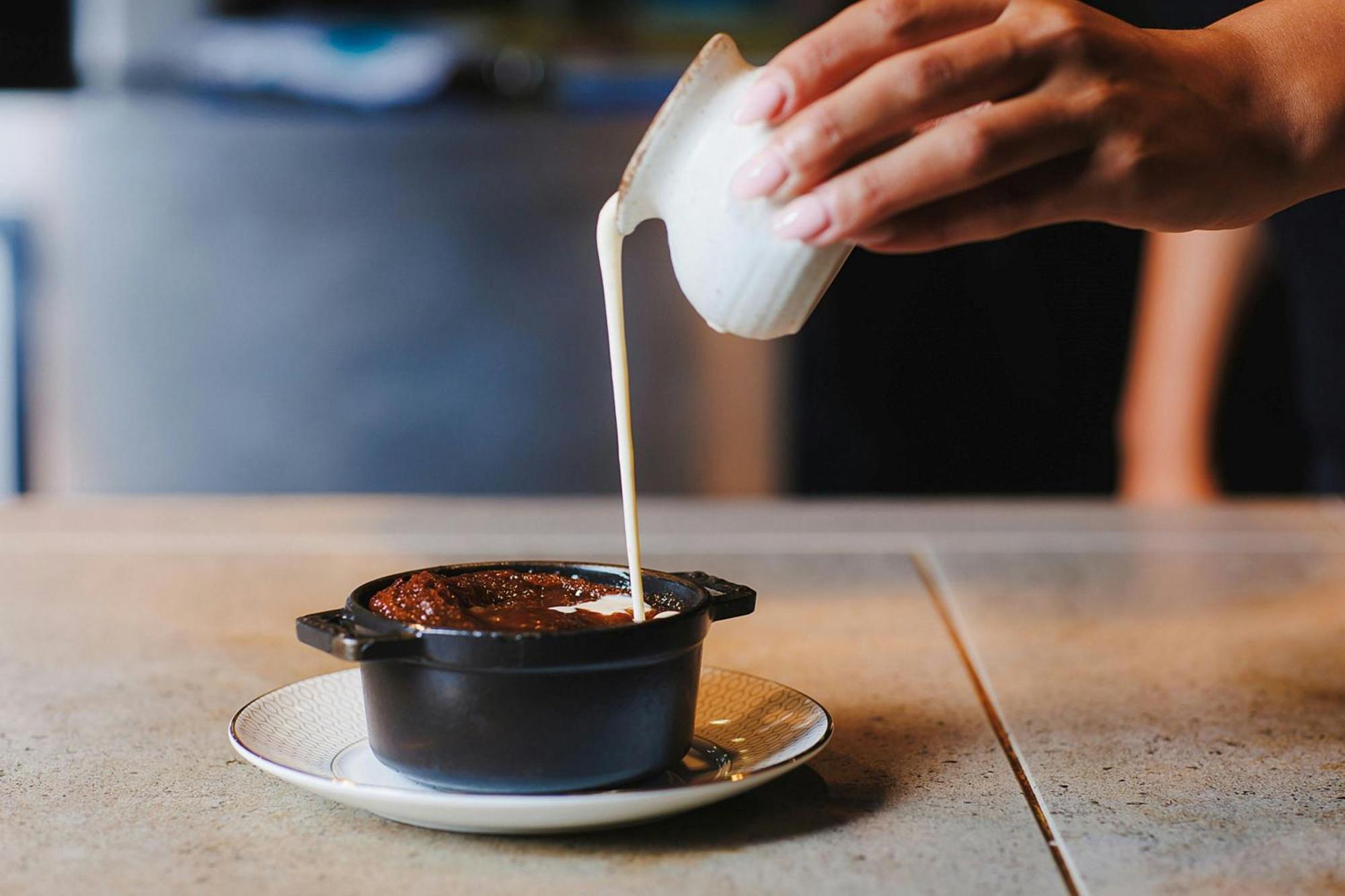 Stock Exchange Hotel, Manchester, Autograph Collection Екстер'єр фото A pot of chocolate pudding being topped with cream